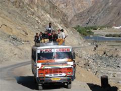 Bus with people on the roof